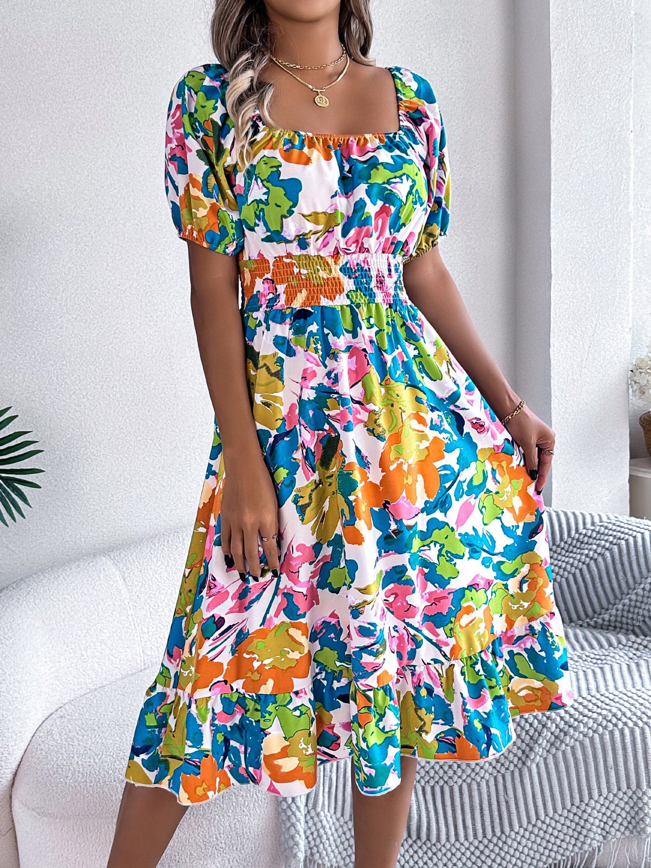 Model twirls in a floral A-line ruffle dress with square collar and short sleeves, styled for summer festival vibes, movement, and confident self-expression.