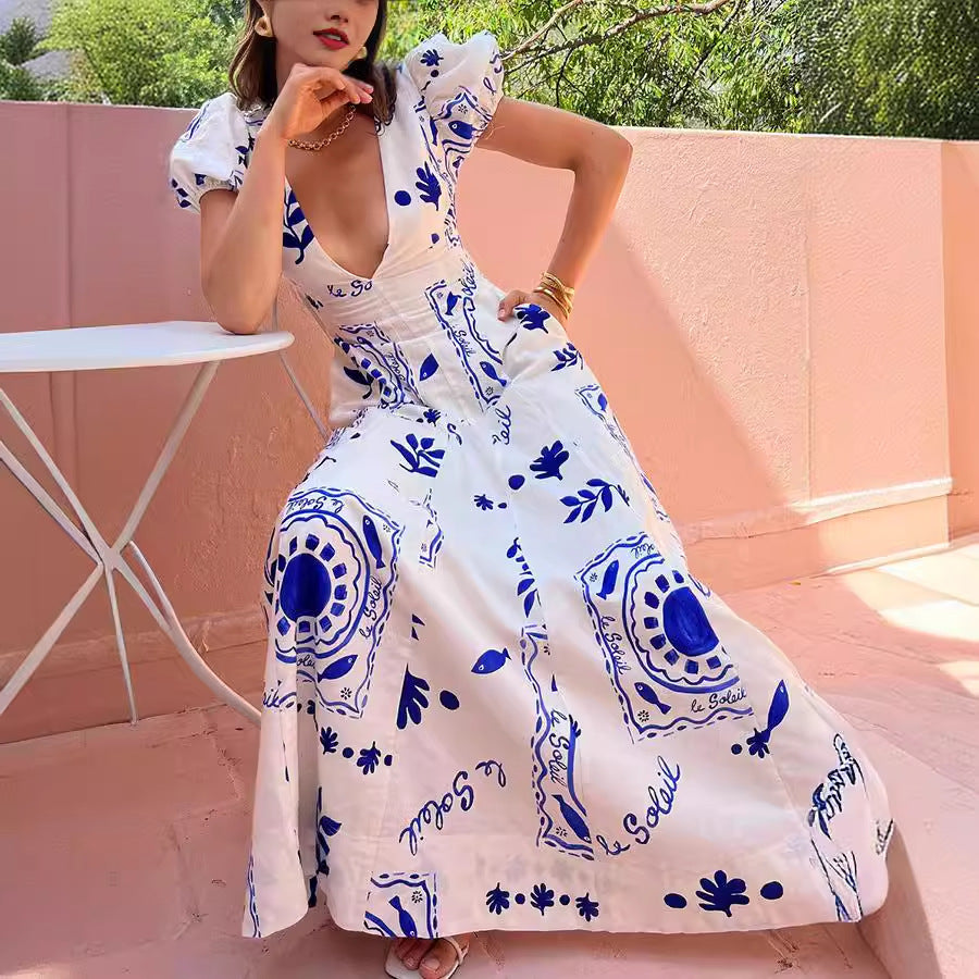 Bold festival-goer in a low cut V neck printed puff sleeve cotton linen dress, twirling freely outdoors, embracing vibrant self-expression and confidence.