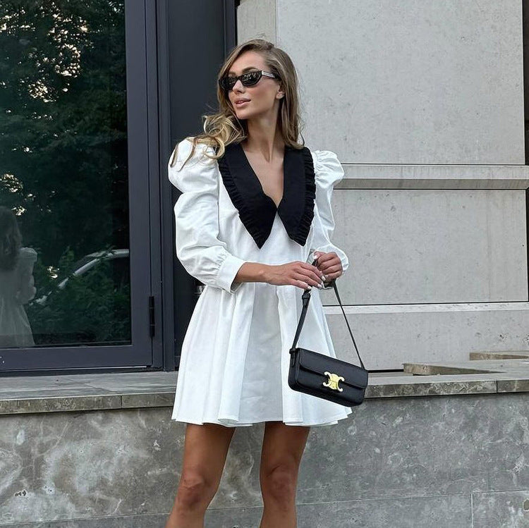 Black and white doll collar dress with pleated A-line silhouette, styled for rave, festival, and nightlife looks; bold, chic, and movement-ready.