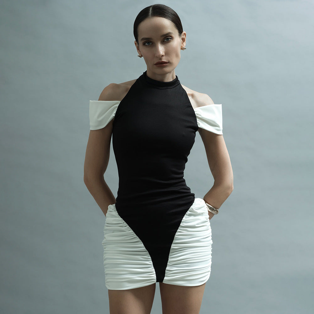 Woman dancing in a vibrant patchwork halter dress with bold color blocks at a summer festival, radiating confidence and festival energy.