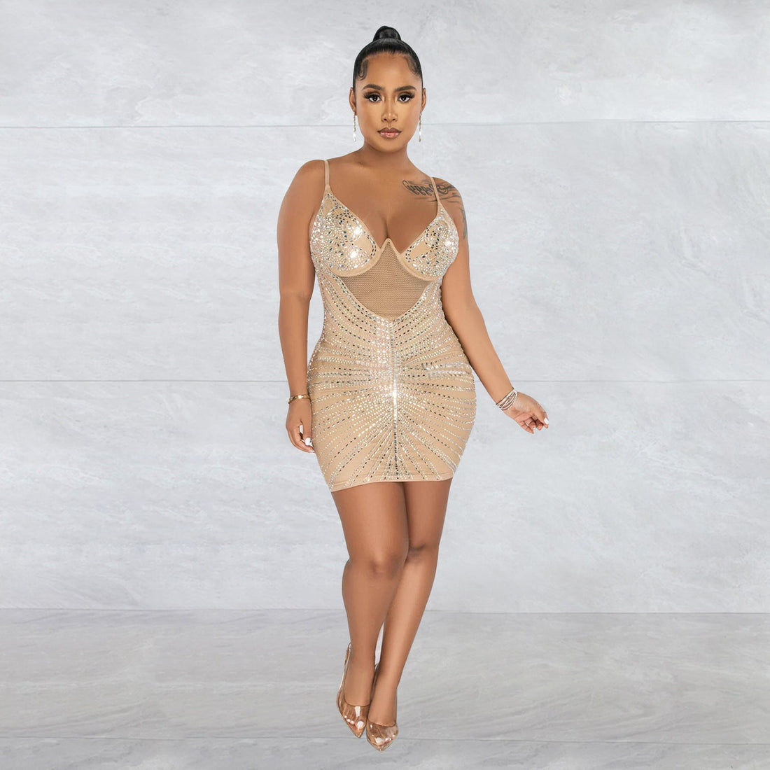 ALT text: Woman dances in a rhinestone mesh camisole dress under colorful festival lights, radiating confidence and bold rave-ready energy.