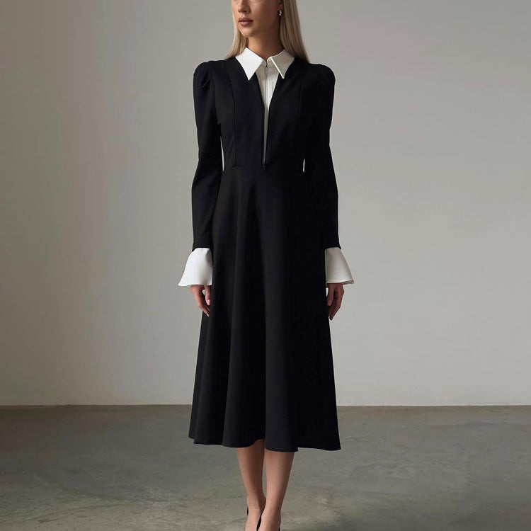 ALT text: Model wears a bold black and white A-line faux two-piece festival dress, standing confidently under vibrant party lights, radiating rave energy.