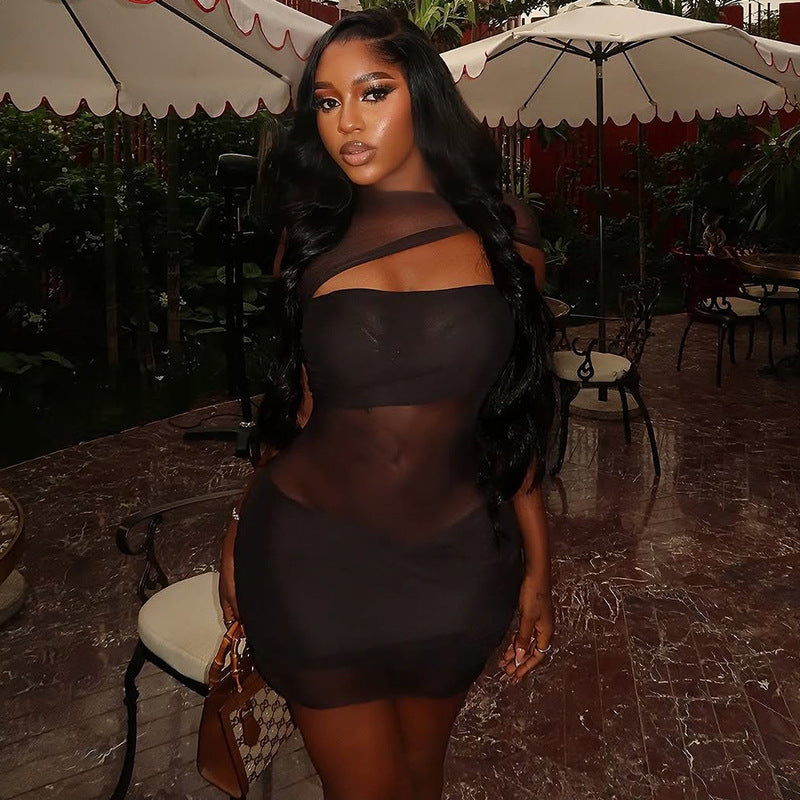 Model wearing a see-through cutout hip skirt dress with high collar, bold silhouette, and futuristic accessories on a vibrant festival dance floor.