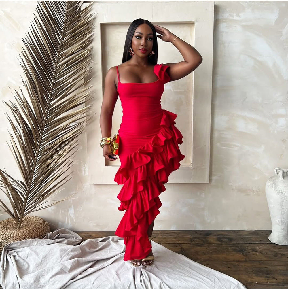 Woman wearing a vibrant, asymmetric ruffled sling dress, dancing at sunset during a festival, exuding movement, confidence, and summer energy.