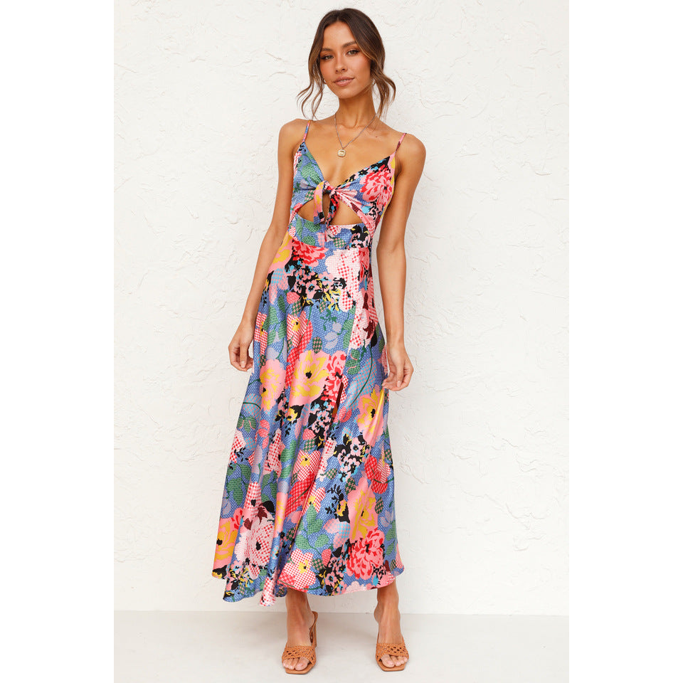 Spaghetti-strap maxi floral dress in vibrant colors, styled with boots and neon accessories, perfect for dancing at festivals under the sun.