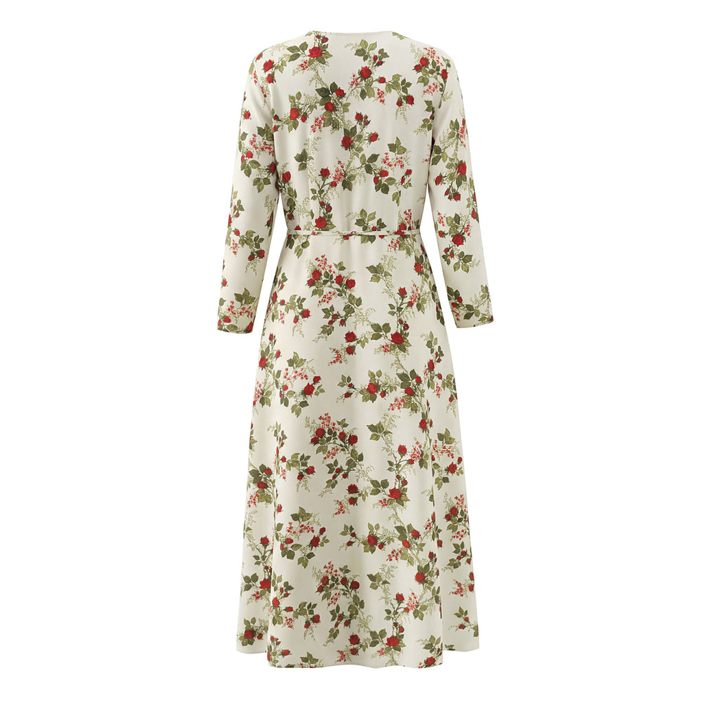 Vestido tipo manta con estampado floral idílico, cuello con lazo y cintura ajustada, mangas largas y bajo el vientre.