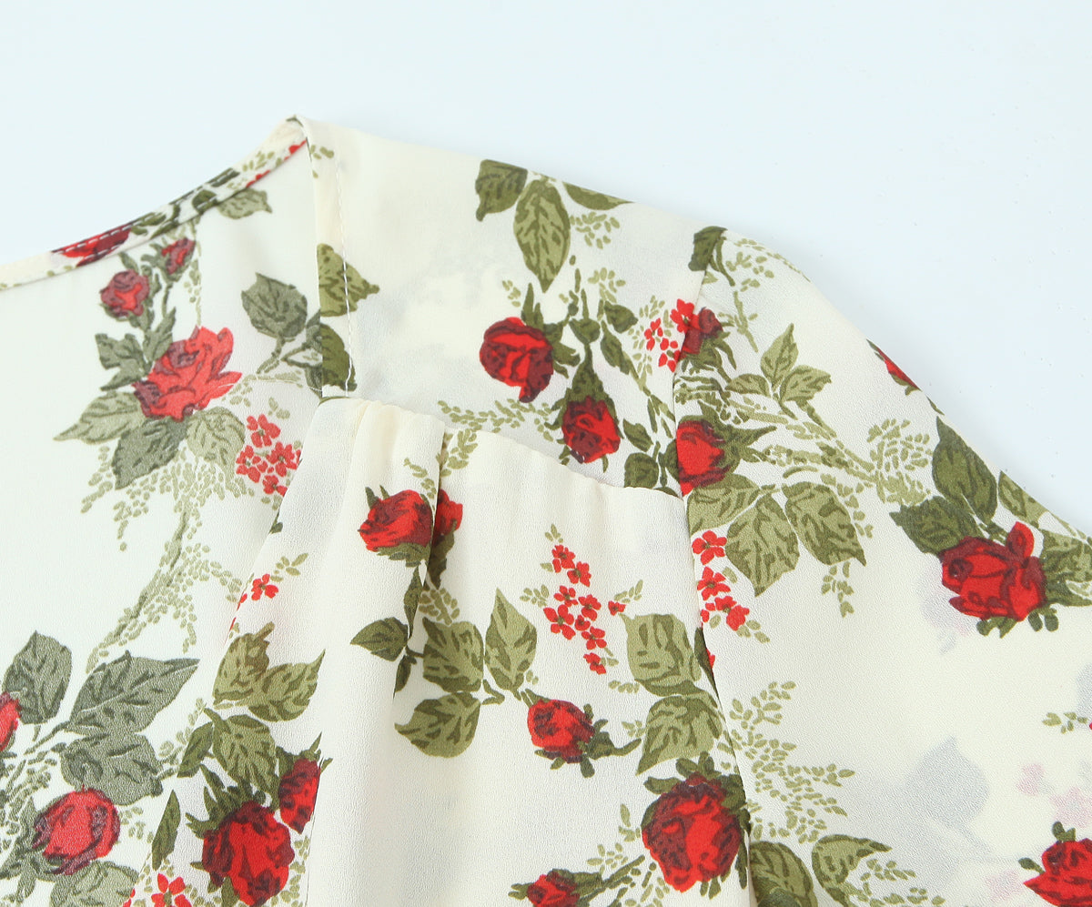 Vestido tipo manta con estampado floral idílico, cuello con lazo y cintura ajustada, mangas largas y bajo el vientre.